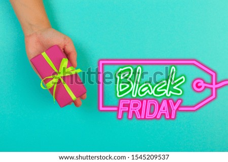 gift in female hands on a colored background top view.Black friday sale