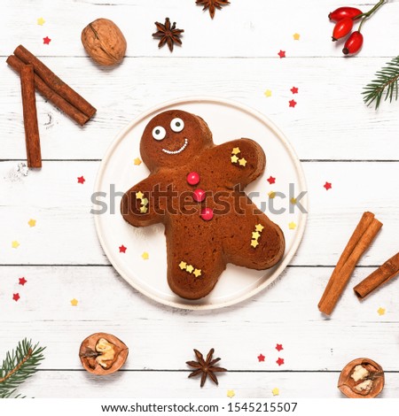 Top view of homemade smiling gingerbread man cake. Christmas food concept. Square image. 