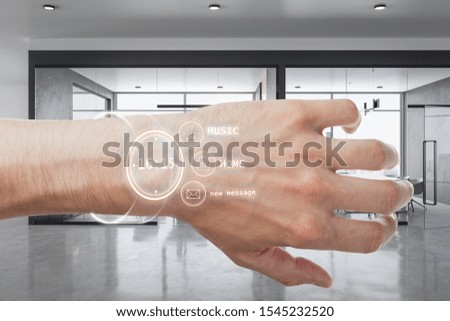 Close up of hand with smart watch hologram on blurry office interior background. Innovation and gadget concept