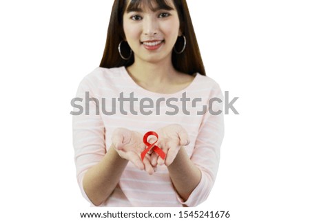 Asian woman is holding red ribbon (Aids Symbol concept) on white isolated background