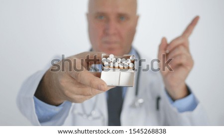 Doctor in Anti Tobacco Campaign Make a Disagree Sign with Cigarettes in Hand
