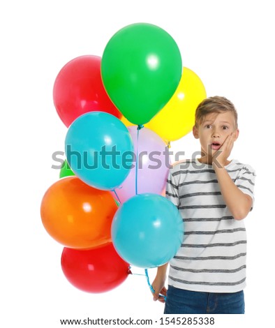 Emotional little boy holding bunch of colorful balloons on white background