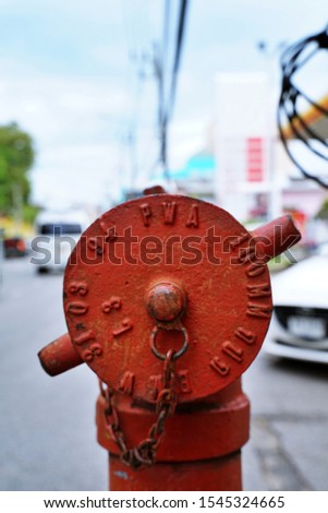 closeup view of red fire hydrant standing on the street in Thailand