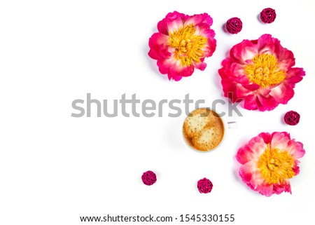 White cup of coffee and beautiful peonies on isolated white desk. Flat lay, top view, copy space.