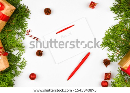 Christmas composition with various objects for writing. Studio shot over christmas background. Layout with empty leaves. place for writing. View from above. On a blue background.