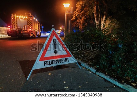 Warning triangle with the inscription fire brigade at night operation