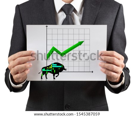 Unrecognizable business man holds paper with with black silhouette bull financial icon.