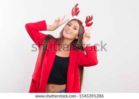 Portrait of happy young woman wearing red jacket and Christmas headband ,long bound hair,happiness,smile on face,perfect skin and body,beautiful Christmas concept , beautiful Europe woman