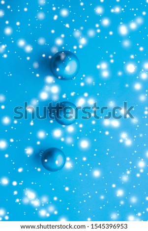 Gift decor, New Years Eve and happy celebration concept - Christmas baubles on blue background with snow glitter, luxury winter holiday card