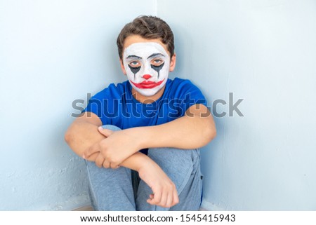 Joker face drawn on some arabic boy