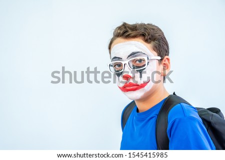 Joker face drawn on some arabic boy