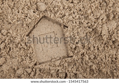 house imprint concept on wet construction sand