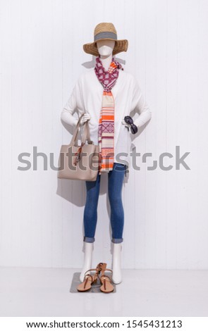 full mannequin in female clothes with blue trousers jeans, ,hat,and scarf, shoes,handbag,sunglasses
