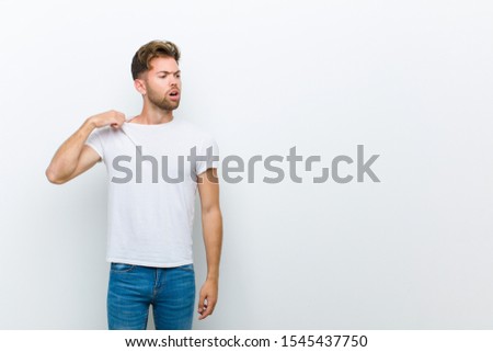 young man feeling stressed, anxious, tired and frustrated, pulling shirt neck, looking frustrated with problem against white background