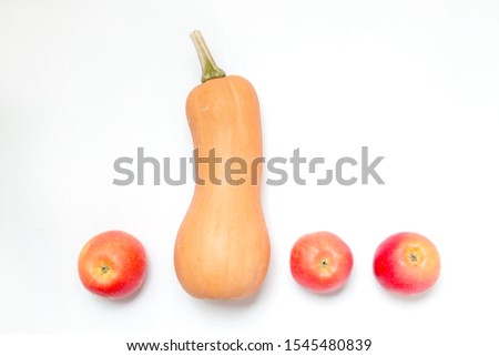 One pumpkin and three apples on a white background. Ingredients for diet salad or freshly squeezed juice.