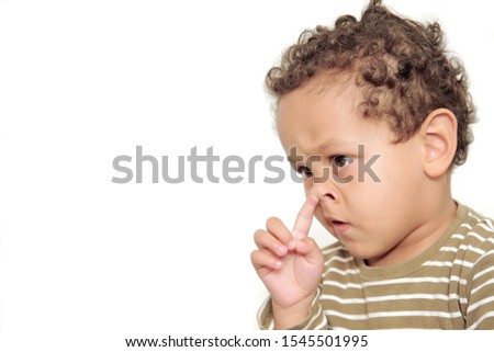 boy picking his nose wiith white background stock photo