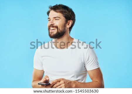 Happy man with mobile phones smiling and looking to the side