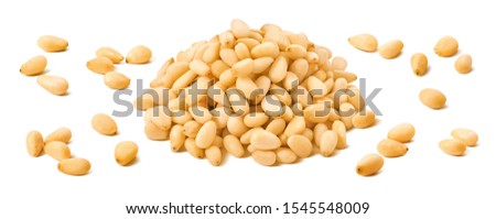 Pine nuts pile and separate kernels isolated on white background. Package design element with clipping path Royalty-Free Stock Photo #1545548009