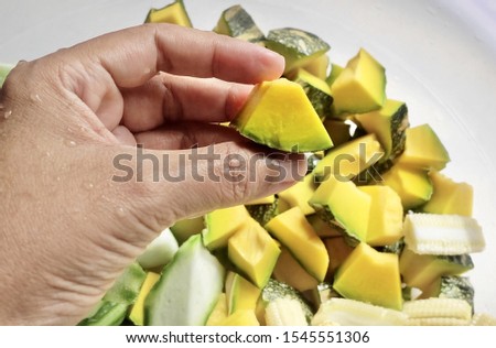 Vegetable, Hand Holding Raw Chopped Angled Gourds or Sponge Gourds with Pumpkins and Baby Corns Preparing for Cooking.