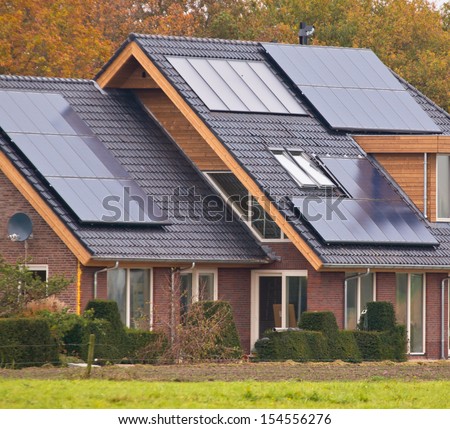 Photovoltaic Solar Panels on Newly Built Modern House Royalty-Free Stock Photo #154556276