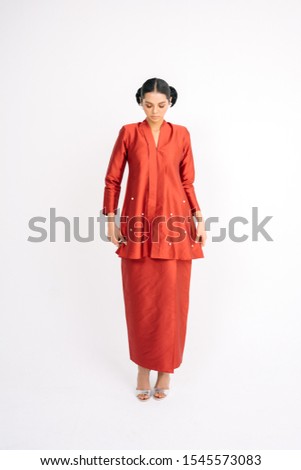 Beautiful female model wearing Asian traditional dress for Muslim woman isolated over white background.Eid ul fitr fashion and beauty.