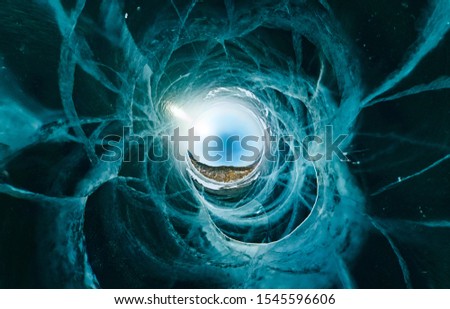 Blue ice sphere covered with cracks on a blue background, the stereographic view of little planet
