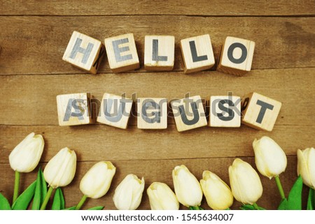Hello August alphabet letters on wooden background