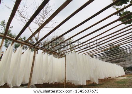 white sheets of fabric which are dried in the sun before being colored