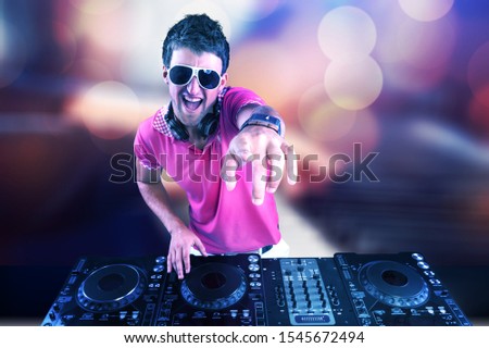 Dj mixes the track in the nightclub at a party, Christmas, new year