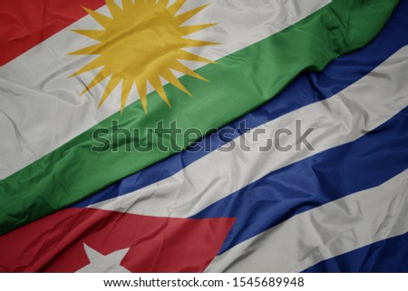 waving colorful flag of cuba and national flag of kurdistan. macro