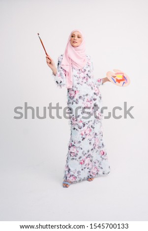 Beautiful Arab Female model wearing hijab isolated over white background.Close up shot.Hijab Fashion.