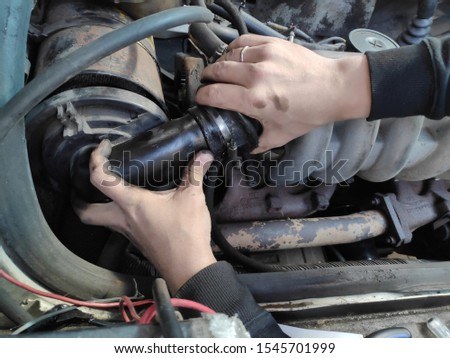 hand of men working in car with enigne, automotive