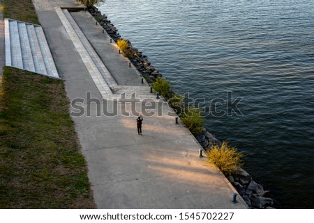 A woman walking along the Hangang River park.