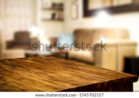 Corner table background of free space for your decoration and blurred home interior with brown sofa. Christmas time in home and warm light.  Royalty-Free Stock Photo #1545702557