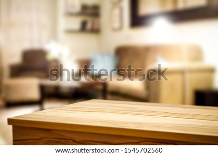 Corner table background of free space for your decoration and blurred home interior with brown sofa. Christmas time in home and warm light.  Royalty-Free Stock Photo #1545702560
