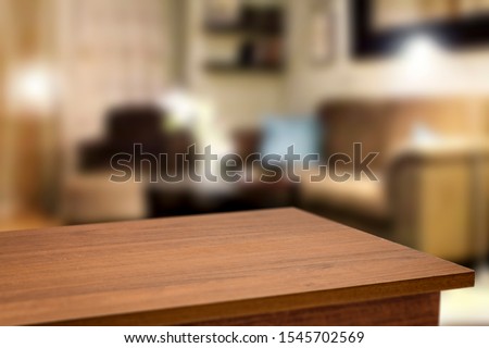 Corner table background of free space for your decoration and blurred home interior with brown sofa. Christmas time in home and warm light. 