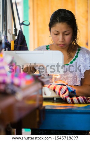 Guatemalan woman working with textiles in in San Juan La Laguna, Lake Atitlan, Guatemala