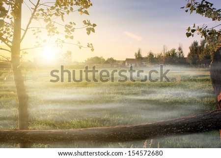 Foggy sunrise at farmland in autumn