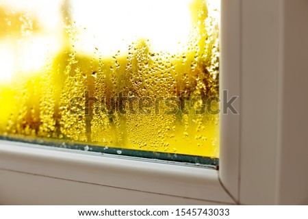 Window drip due to bad ventilation inside house. Condensation on glass during cold weather. High humidity is cause of mold (mildew, mould) on house or building surfaces. Water drop tracks on windows.  Royalty-Free Stock Photo #1545743033