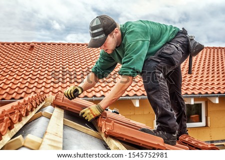 Roofer at work, installing clay roof tiles, Germany Royalty-Free Stock Photo #1545752981