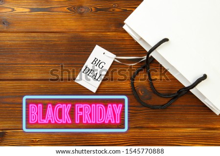 Paper bag on wooden  background with sale tag .  Black friday sale- Image 