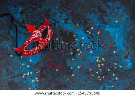 mask, confetti on a blue background
