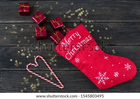 Santa sock with gifts, confetti, candies - christmas background