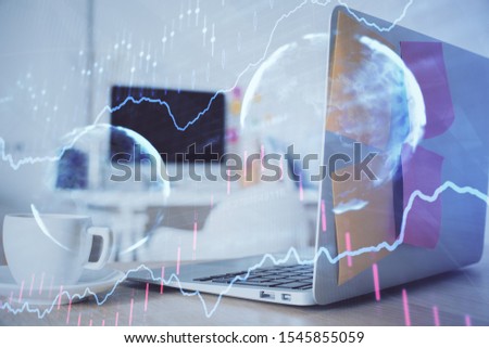 Stock market graph on background with desk and personal computer. Double exposure. Concept of financial analysis.