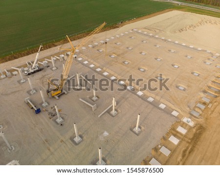 Aerial view of two cranes on a building site of a new factory in the country