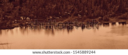 small houses on the mountain among the forests on the river bank, landscape, reflection in the water, monochrome
