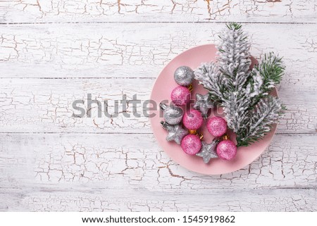 Christmas background with fir tree and pink and silver balls. Top view