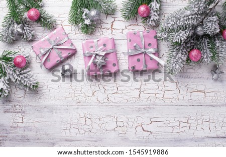Christmas background with gift box in pink paper. Top view