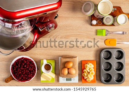 Ingredients for baking muffins on wooden table