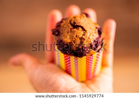 Banana-cherry bite size muffin on a palm Royalty-Free Stock Photo #1545929774